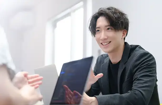 打ち合わせのイメージ（タブレットで説明するスタッフ）